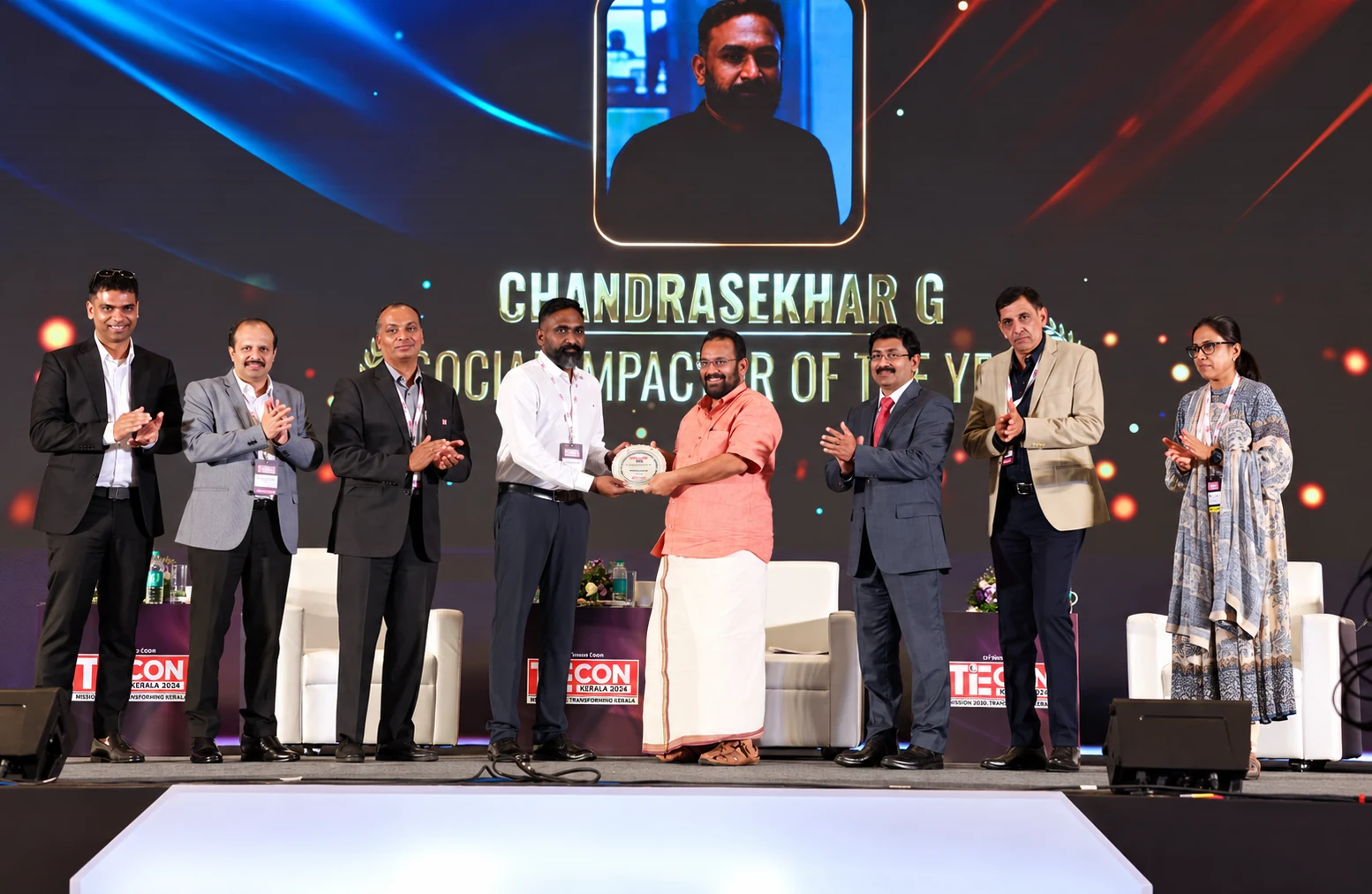 Chandrasekhar G receiving the Social Impactor of the Year award on stage at TiEcon Kerala 2024